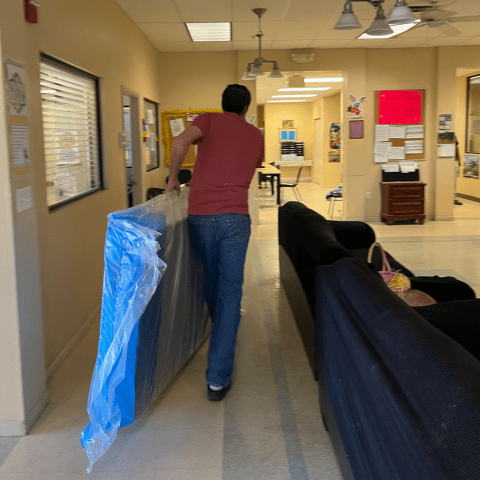 Person moving furniture at a residential facility
