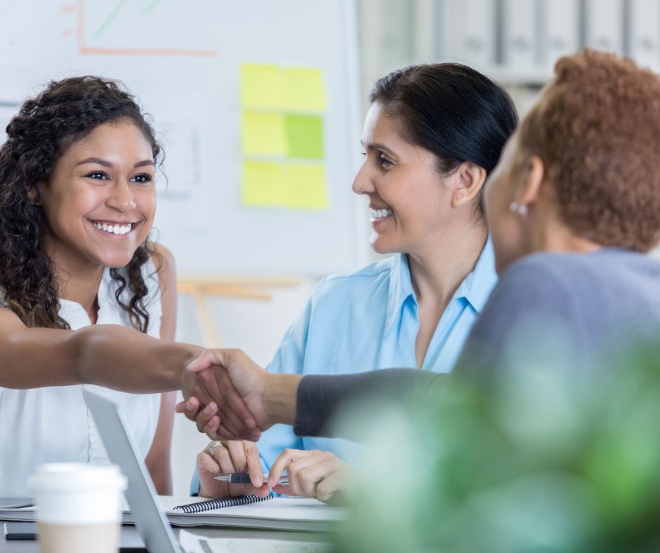 tbjl-meet-shakehands woman in meeting shaking hands with another woman<br />