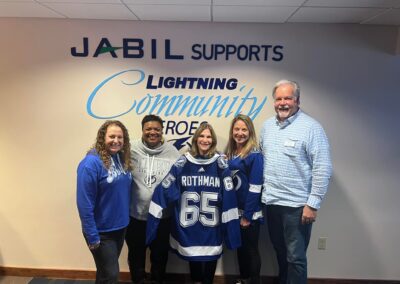 Margie Rothman Honored As Lightning Community Hero standing alongside board and CEO
